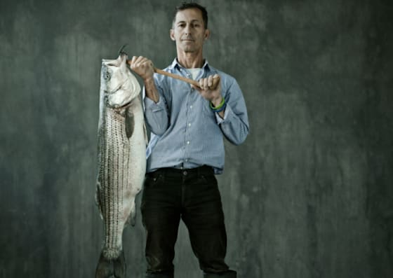 Portrait Photograph of man with caught fish