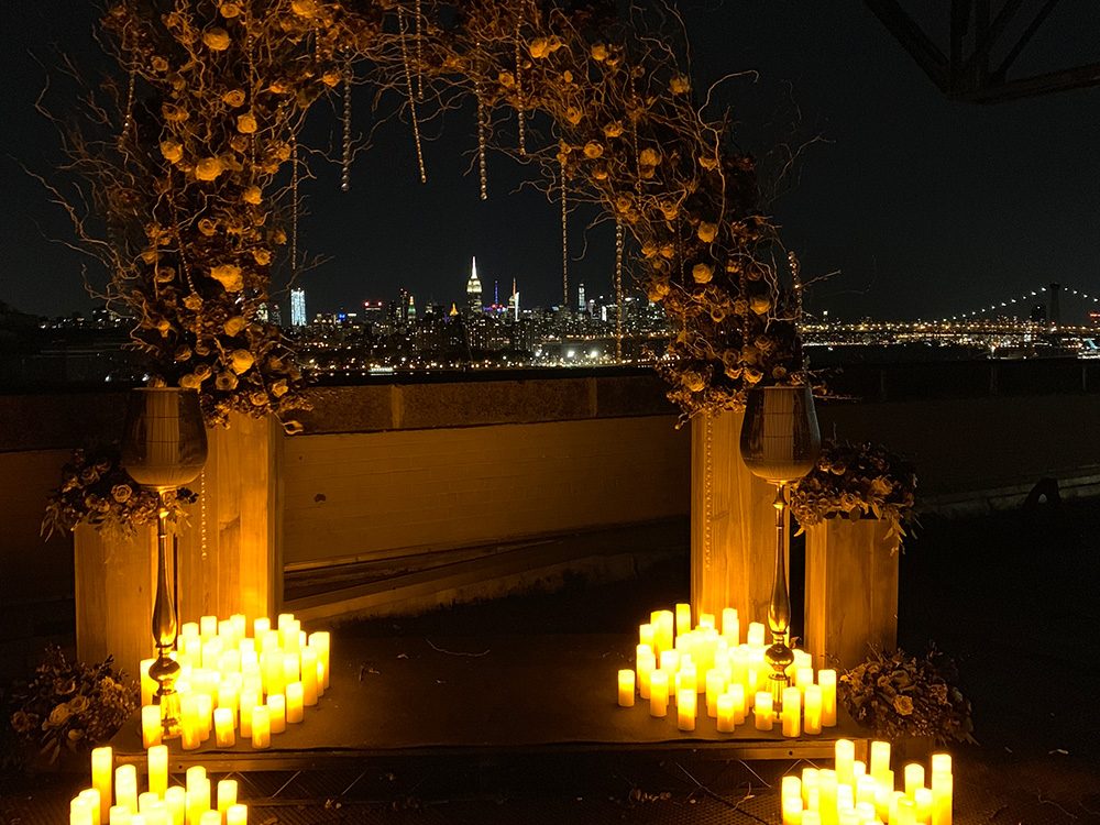 Brooklyn Waterfront Rooftop decorated for wedding ceremony with candles and view of lower manhattan at ten ton studios